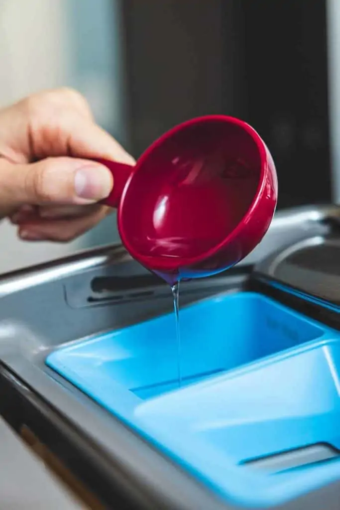 Pouring detergent into a washing machine