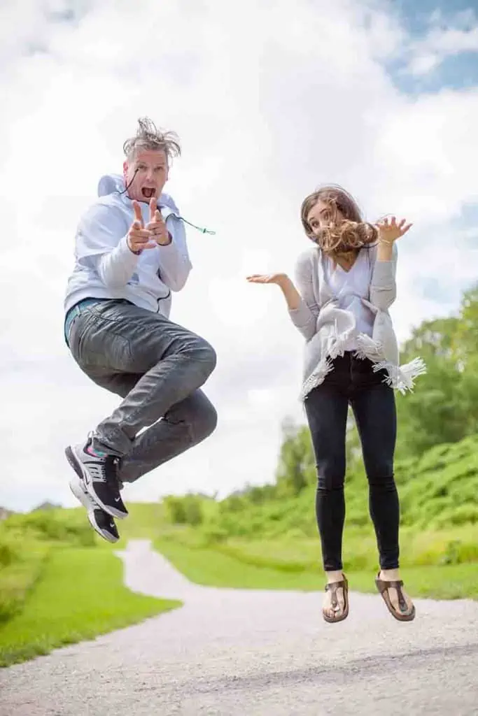 Melissa and chad jumping in the park